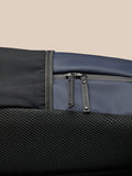 Model wearing navy Active Small Backpack on back in side profile.