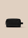 Side view of black Active Wash Bag showing a sturdy strap and durable fabric texture.