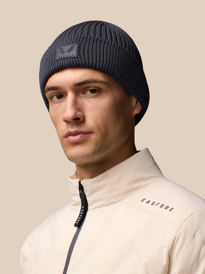 Grey knit beanie with Castore logo patch on the front