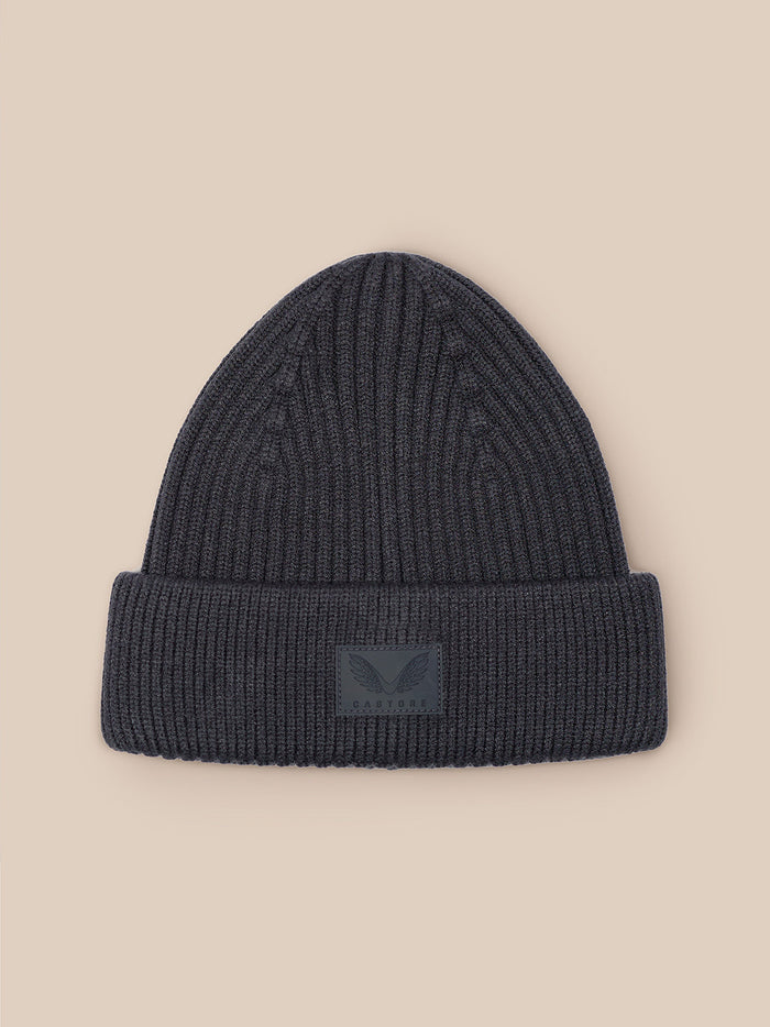 Grey ribbed Active Beanie with front Castore logo patch on beige background