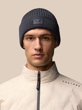 Model wearing dark grey ribbed knit beanie with Castore patch and beige jacket