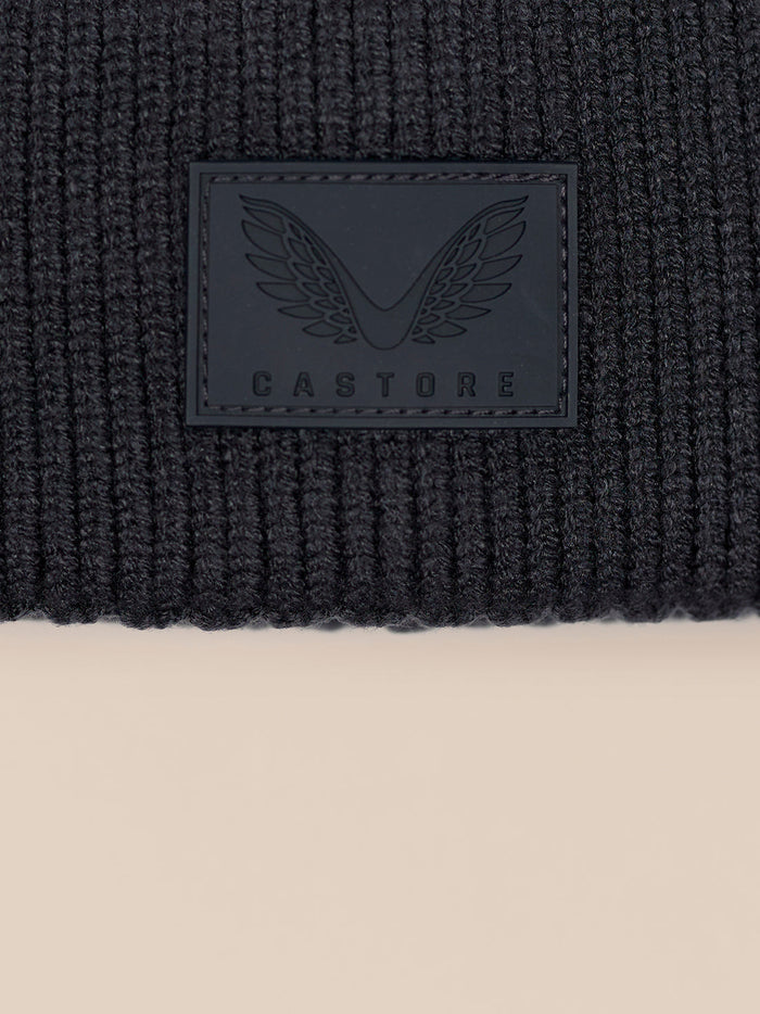 Close up of ribbed knit fabric with Castore logo patch on the beanie cuff