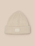 Stone ribbed knit beanie laid flat against a beige background with a front Castore label