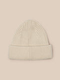Beige ribbed knit beanie on a model with the Castore badge at the front