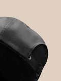 Back view of charcoal cap with adjustable strap and wing logo tag.