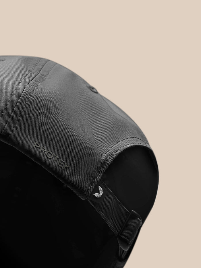 Back view of charcoal cap with adjustable strap and wing logo tag.