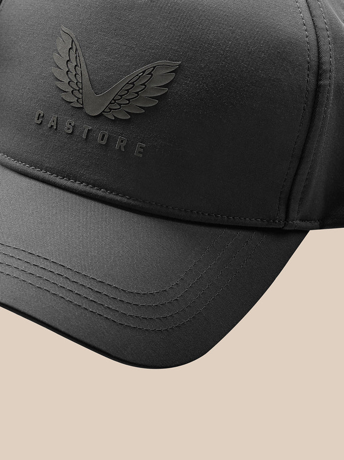 Close-up of charcoal cap side showing stitched brim and Castore branding.