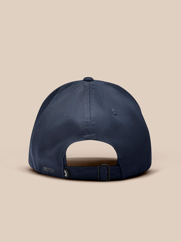 Back view of navy Castore cap with adjustable strap and Protek branding