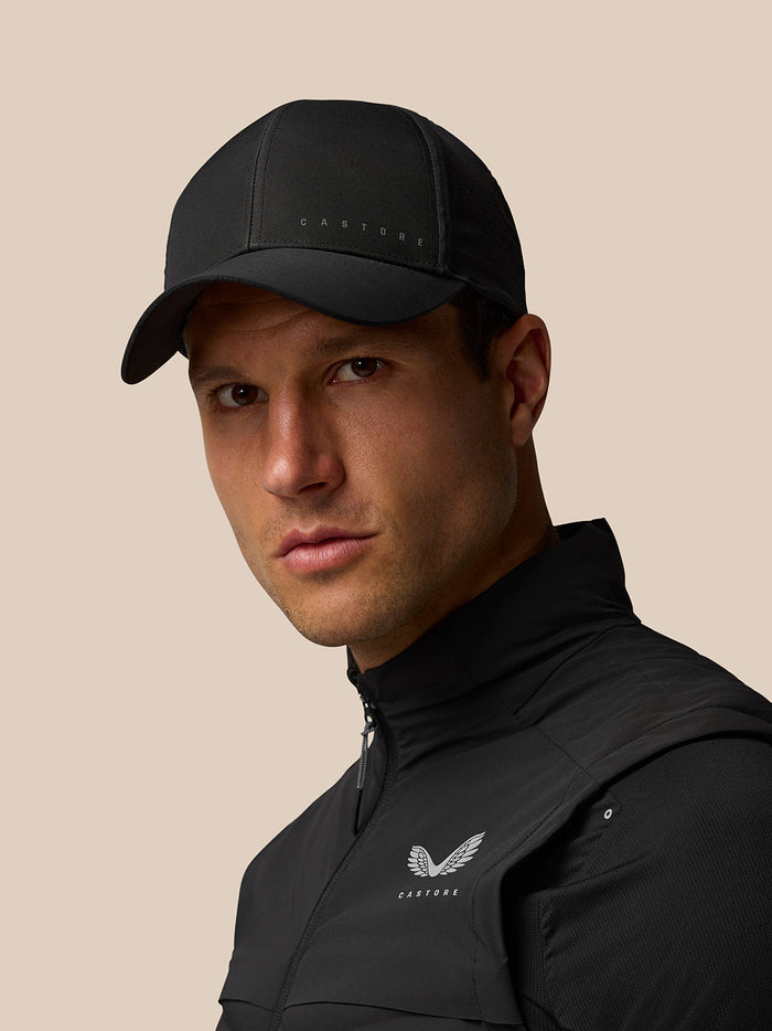 Male model wearing black nylon Active Logo Cap with Castore branding and curved brim