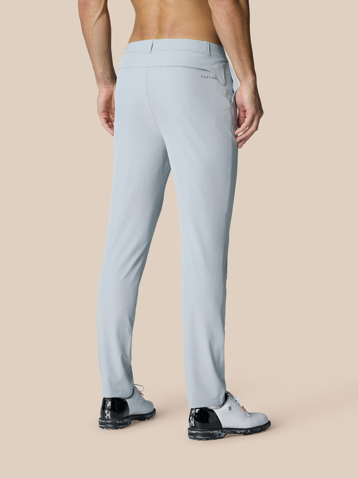 Back view of a man wearing light grey Castore Golf Club Trousers showing belt loops and rear pocket.