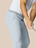 Male model wearing mid grey Golf Club Trousers with a woven belt, highlighting open side pockets and a back pocket