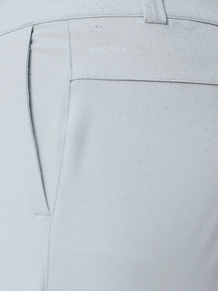 Close up of light grey Golf Club Trousers showing ProTek fabric with water droplets and rear pocket seam.
