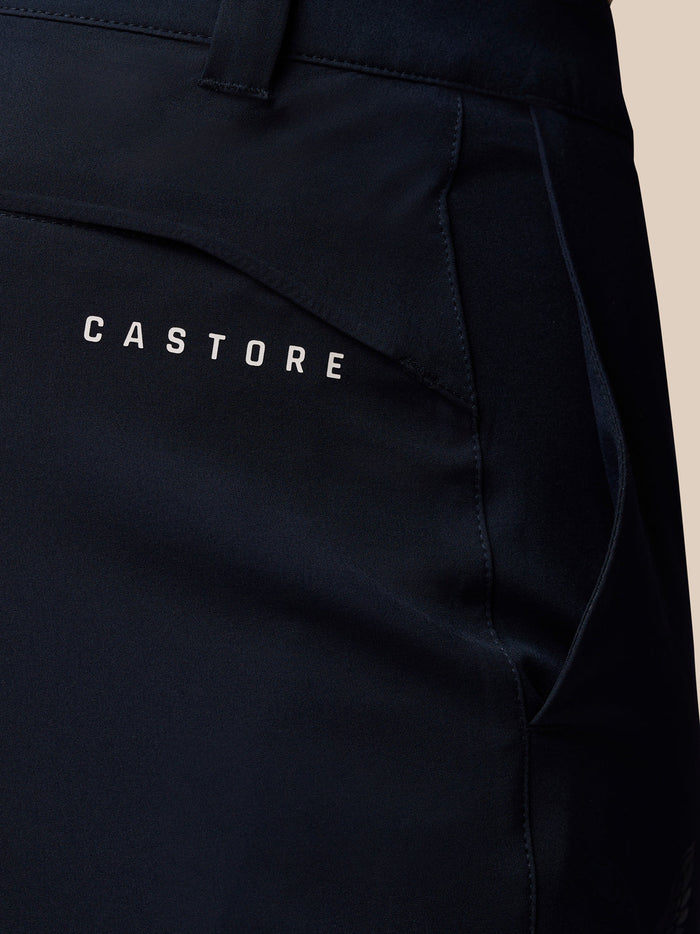 Close up of navy golf trousers back pocket showing Castore branding.