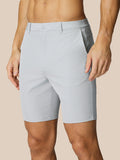 Light gray golf shorts with belt loops and side pockets on a male model.