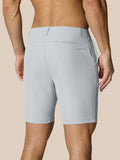 Back view of light grey golf shorts on a model showing waistband with belt loops, back pocket at right rear and branding on the right thigh