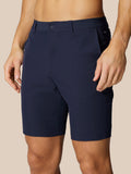 Navy golf lightweight shorts with belt loops and side pockets worn by male model