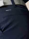 Close up of navy golf shorts with a gray woven belt showing back pocket and ProTek branding at left rear waistband.