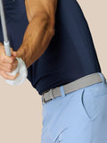 Back view of sky blue golf shorts showing a woven belt and ProTek branding on the back pocket