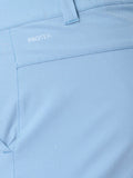 Close up of sky blue Castore golf shorts fabric with water droplets and ProTek branding near the belt loop