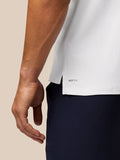 Close-up of polo hem with AERTEK branding at lower back and a small side slit.