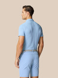 Back view of a man wearing Sky Blue Golf Club Essential Polo with Castore branding on the upper back