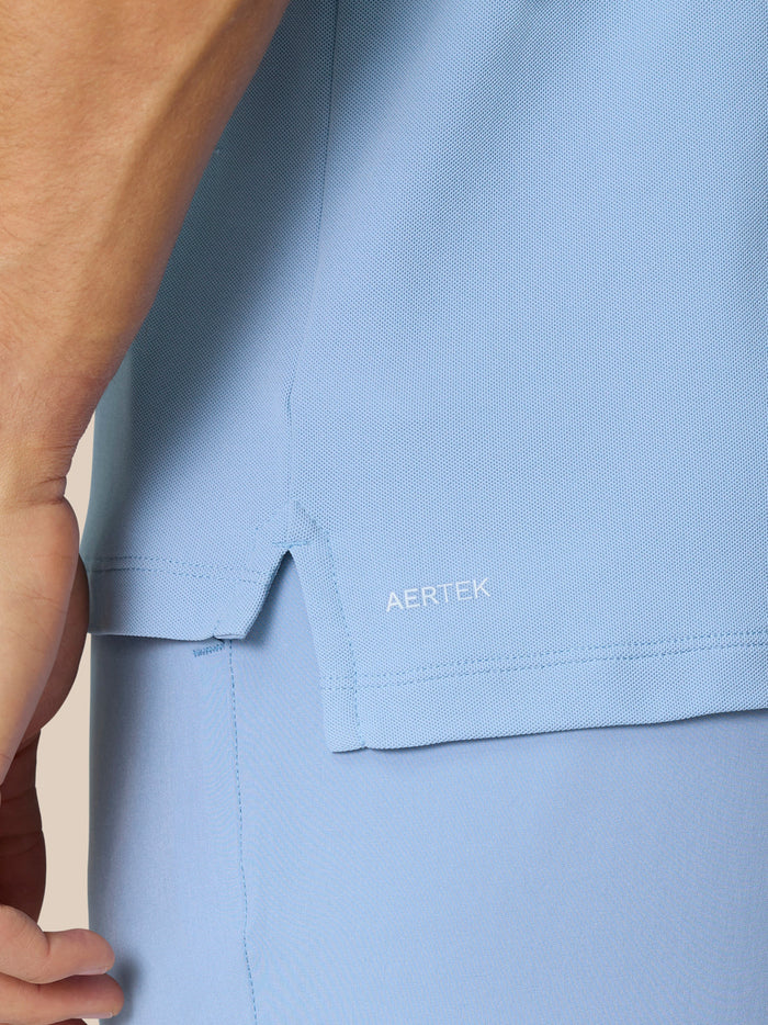 Close-up of sky blue Golf Club Essential Polo fabric with AERTEK label.