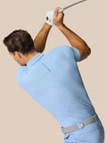 Golfer in Sky Blue Golf Club Essential Polo mid swing with Castore branding along the back and chest