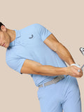 Side view of a man in Sky Blue Golf Club Essential Polo showing Castore branding on left chest and upper back