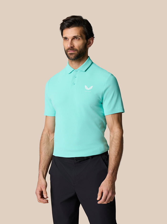 Man modeling light aqua Golf Club Essential Polo with white logo on chest