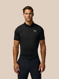 Front view of a man wearing a black Pinnacle Pique Stripe Polo with striped knit fabric and Castore logo on the chest
