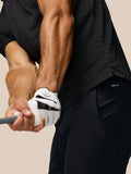 Side-back view of a man in the Golf Pinnacle Pique Stripe Polo in black alloy with stripes and Castore branding on the upper back