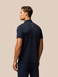 Back view of a navy Pinnacle Stripe golf polo showing subtle horizontal stripes and Castore branding along the upper back.
