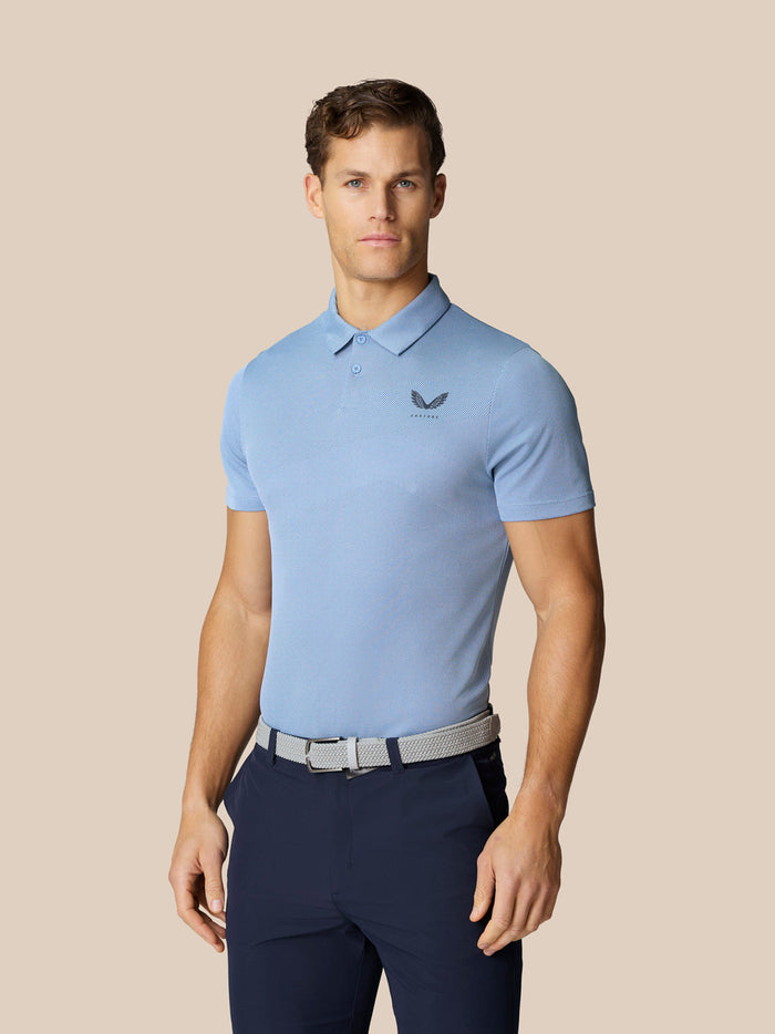 Male model in a sky blue polo with collar and belt, posing from the front.