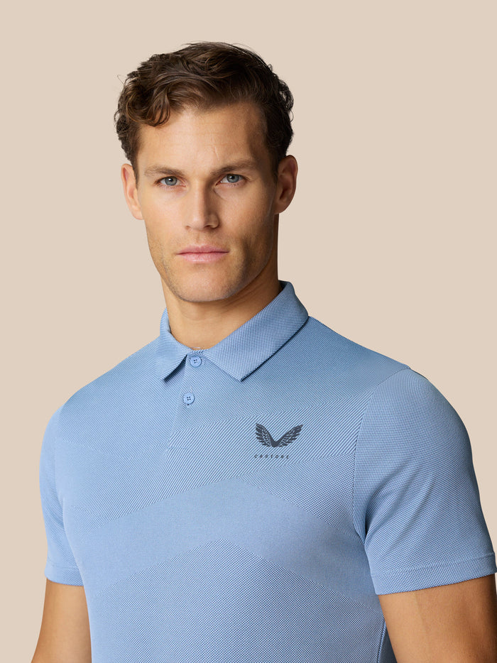 Front view of a man wearing sky blue Engineered Knit Polo with chest logo and textured knit.