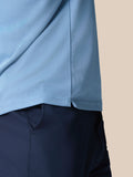 Close-up of light blue engineered knit fabric showing texture and side hem of Golf Pinnacle Polo