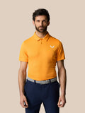 Male model wearing bright mango golf polo with collar and short sleeves; white logo on chest against a beige background.