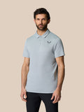 Male model wearing Golf Pinnacle Polo in mid grey with breathable textured knit fabric.