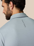 Back view of a mid grey polo showing CASTORE branding along the upper back.