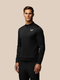Man wearing black long sleeve quarter zip top with Castore branding on the left chest