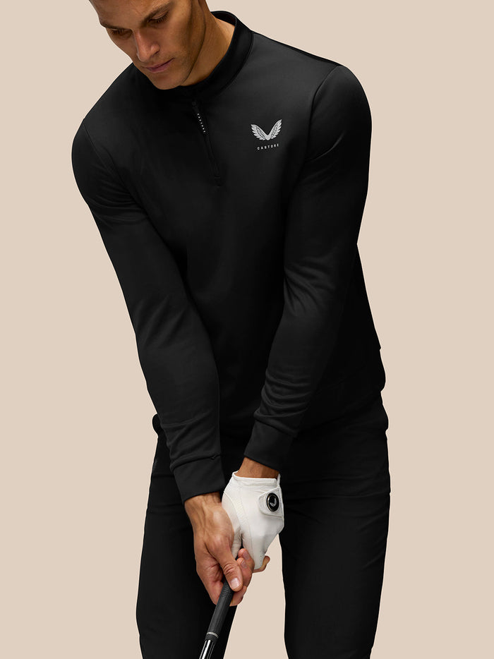 Person wearing black Golf Club Classic top with quarter zip; Castore branding visible on chest and upper back.