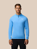 Man wearing light blue Golf Club Classic 1/4 Zip Top with stand collar and left chest logo.