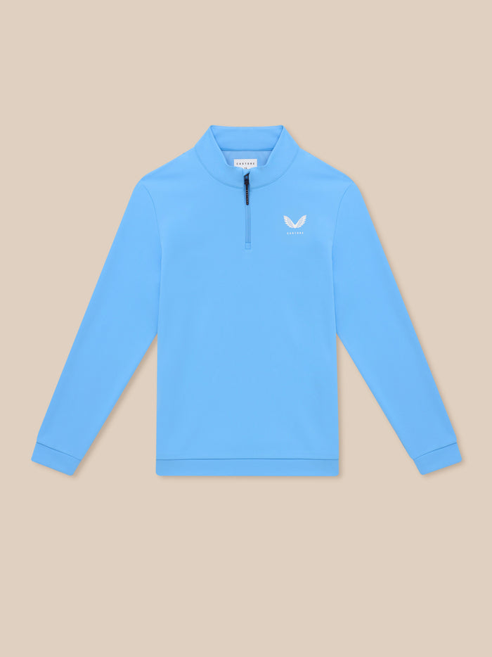Close-up of light blue Castore Golf Club Classic quarter zip top showing the front zip and left chest logo.