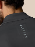 Close-up of a gunmetal golf quarter zip top seen from the back with Castore branding along the upper back.