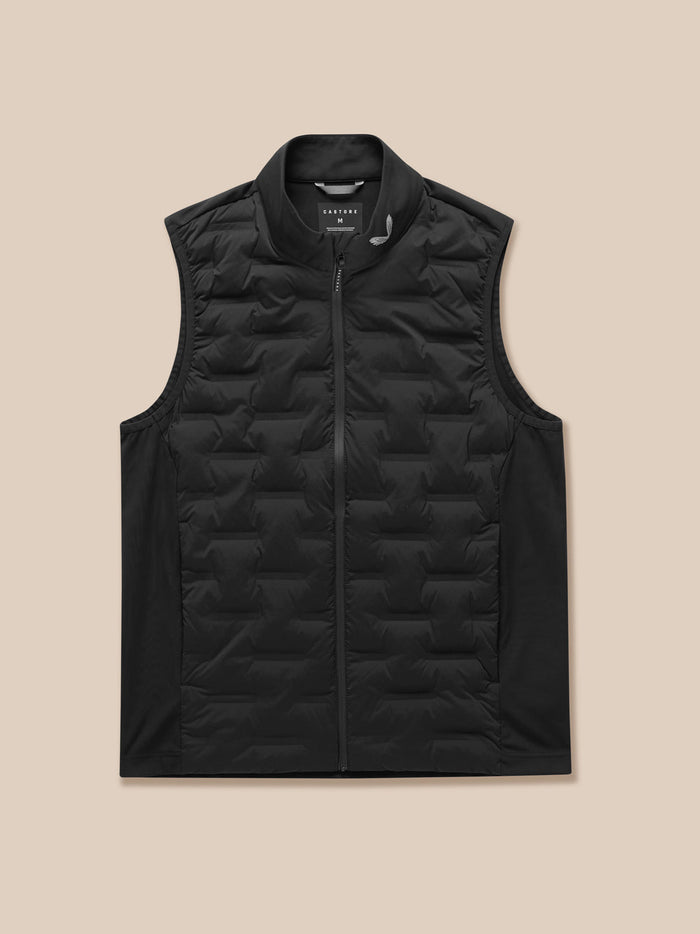 Model in black Pinnacle Golf Gilet with front zip and stand collar; full length view of quilted sleeveless vest worn over dark pants.
