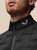 Close-up of the stand collar on the black gilet showing a silver wing logo and Protek branded zipper pull.