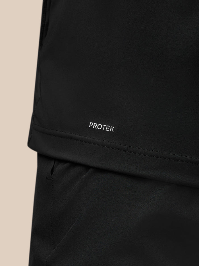 Close-up of the lower back area of the black gilet with Protek branding.