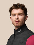 Side profile of a man wearing a black Pinnacle Gilet, collar featuring the Castore emblem.