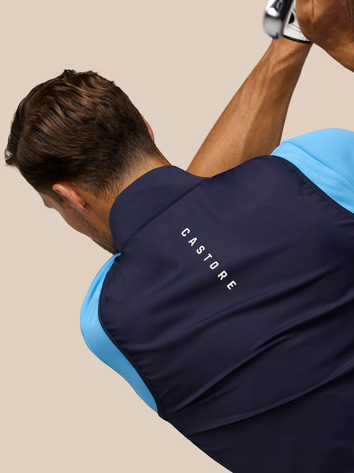 Back view of midnight navy Pinnacle Gilet with CASTORE branding along the upper back.