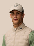 Close up of a male model wearing Mushroom Golf Pinnacle Lightweight Hybrid Gilet with funnel collar and Castore logo at the collar
