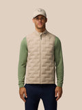Male model wearing Mushroom Golf Pinnacle Lightweight Hybrid Gilet with cap, featuring the front zip and quilted panel